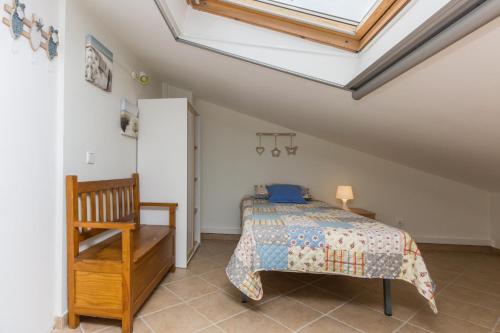 a bedroom with a bed and a skylight at 4 bedroom villa wi-fi and shared pool by ALGARVEMANTA in Manta Rota