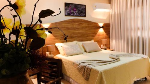 a bedroom with a bed and a plant at Terra dos Diamantes Hotel in Lençóis