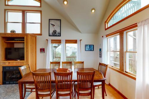 a dining room with a wooden table and chairs at Enduring Freedom #6-8 in Avon