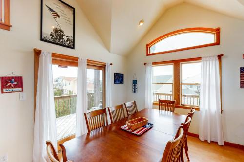 a dining room with a table and chairs and windows at Enduring Freedom #6-8 in Avon