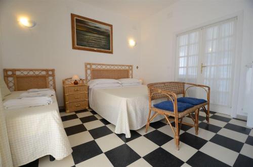 1 dormitorio con 2 camas y suelo a cuadros en Nautilus, en Castagneto Carducci