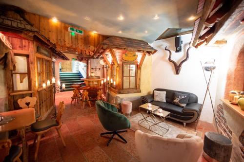 a living room with a couch and chairs at Alpines Lifestyle Hotel Tannenhof in Sankt Johann im Pongau