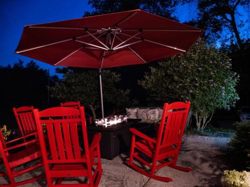 a group of red chairs and an umbrella at The Homestead in Madison