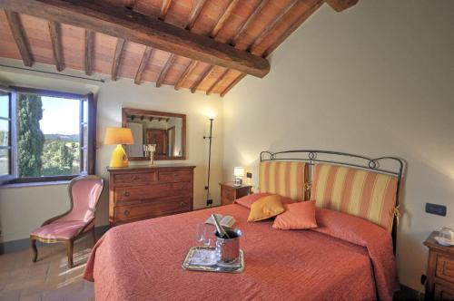a bedroom with a bed and a dresser and a window at La Rana in Gaiole in Chianti