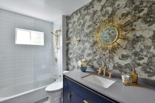 a bathroom with a sink and a toilet and a mirror at Luxury Cardiff by-the-Sea Ocean View Penthouse in Encinitas