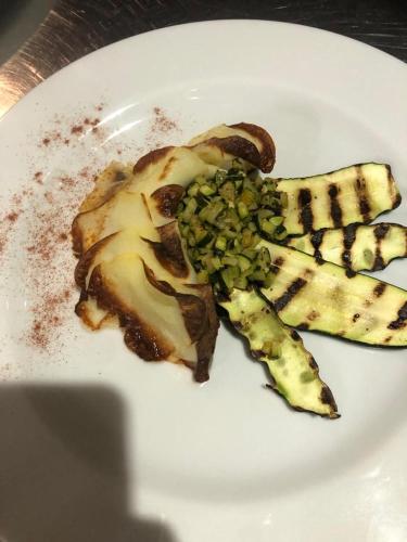 a white plate with a piece of food on it at Sea Palace Hotel in Marina di Fuscaldo