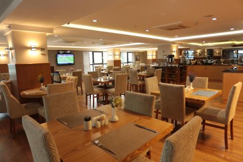 a dining room with wooden tables and chairs at NK Hotel in Izmir