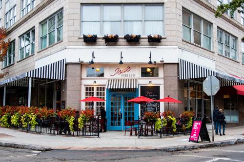 a restaurant with tables and chairs in front of a building at Haywood Park Hotel, an Ascend Collection Hotel in Asheville