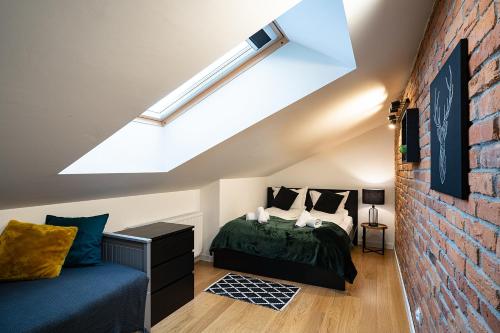 a attic bedroom with a bed and a skylight at Apartamenty Dukla in Dukla