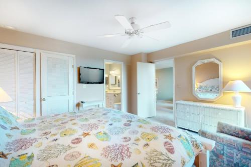 a bedroom with a large bed and a television at Sea Colony Edgewater House IV in Bethany Beach