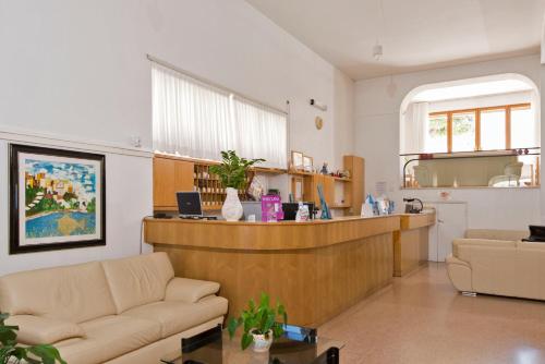 a lobby with a reception desk and a living room at Albergo La Sirenella in Sperlonga