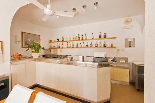 a kitchen with white cabinets and a counter top at Albergo La Sirenella in Sperlonga
