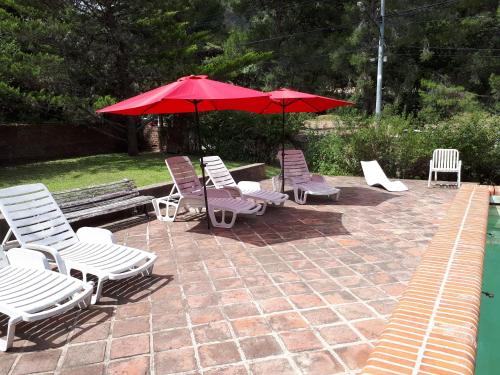 a group of chairs and umbrellas on a patio at Hotel Zapata in La Cumbre