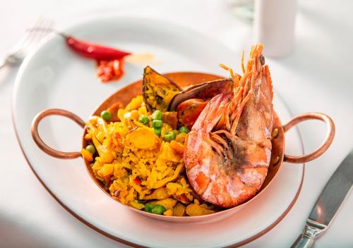 a bowl of food on a plate on a table at Estanplaza Ibirapuera in Sao Paulo