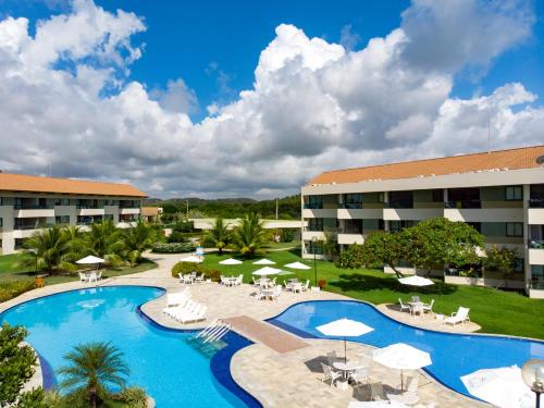 an image of a resort with a large swimming pool at Carneiros Beach Resort in Praia dos Carneiros