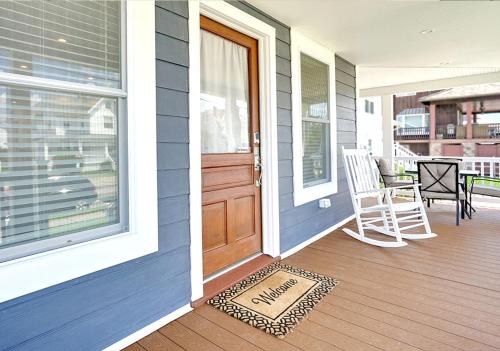 a porch with a door and a chair and a rug at Stylish house one block to beach with linens and parking in Point Pleasant Beach