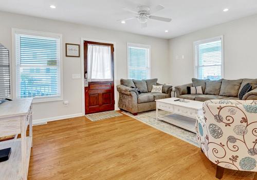 a living room with a couch and a table at Stylish house one block to beach with linens and parking in Point Pleasant Beach