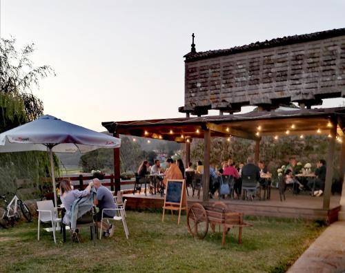 a group of people sitting in chairs under a pavilion at LIRESCA in Lires