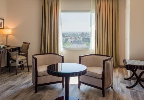 a hotel room with a table and chairs and a window at DiplomaticHotel in Mendoza