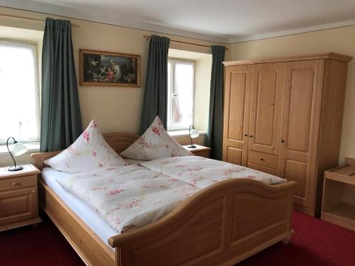 a bedroom with a large bed with flowers on it at Beim Haasen in Grabenstätt