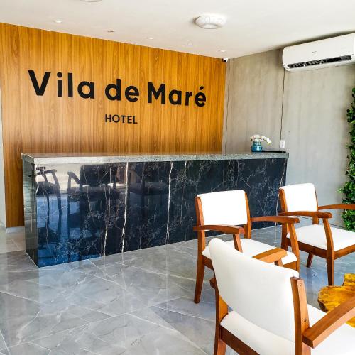 a lobby of a villa de marne hotel with chairs at Vila de Maré Hotel in Porto De Galinhas