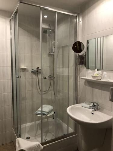 a bathroom with a shower and a sink at Hotel Schöne Aussicht in Weißenfels