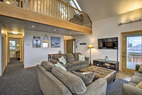 a living room with a couch and a tv at Logan Road Lookout, Lincoln City Home with Game Room in Lincoln City