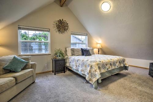 a bedroom with a bed and a couch and a window at Logan Road Lookout, Lincoln City Home with Game Room in Lincoln City