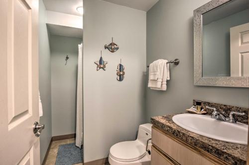 a bathroom with a sink and a toilet and a mirror at Logan Road Lookout, Lincoln City Home with Game Room in Lincoln City