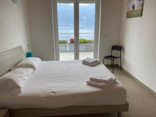 a bedroom with a large bed with a view of the ocean at Residence Il Poggio in Dorio