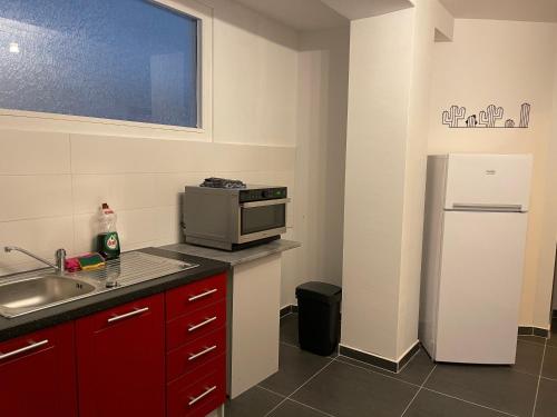 a kitchen with a sink and a refrigerator at Gîtes Sax 3 in Dinant