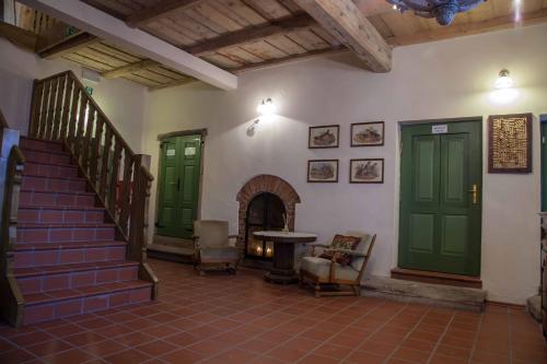 a living room with green doors and a staircase at Karczma Bełty in Glinno
