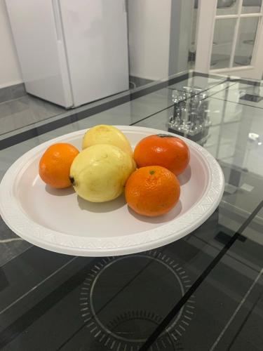 a plate of fruit on a glass table at Travis House Three Luxury Modern Living free WiFi in Burnley