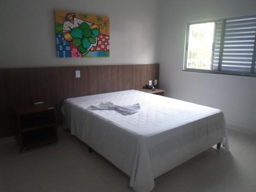 En eller flere senge i et værelse på Hotel Tauari