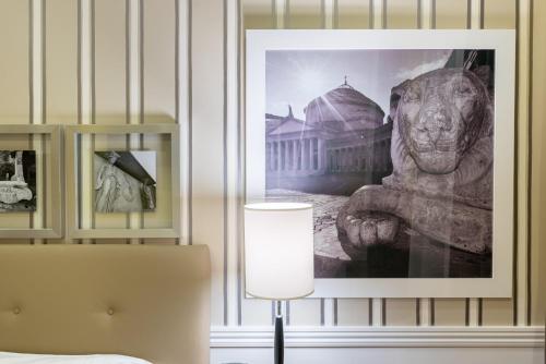 a picture of a statue on a wall with a lamp at Palazzo Turchini in Naples