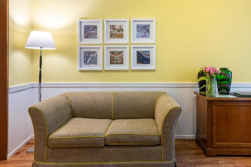 a living room with a couch and pictures on the wall at Palazzo Turchini in Naples