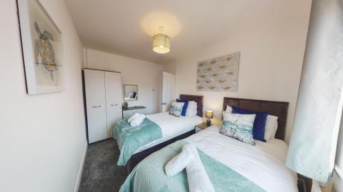 two beds in a small room with two beds at Stunning 3-Bed house in Chester by 53 Degrees Property, ideal for Contractors & Families, FREE Parking - Sleeps 7 in Chester