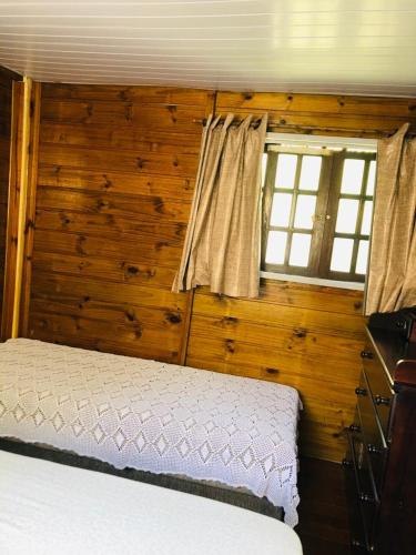 a bedroom with a bed and a window at Casa Ilha do Mel in Ilha do Mel