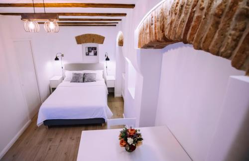 a bedroom with a bed and a table with flowers on it at Chic Central Studio in Sibiu
