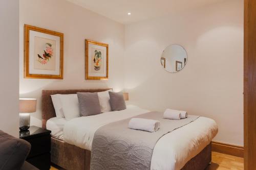a bedroom with a large bed with two pillows on it at StayInn Monument in London