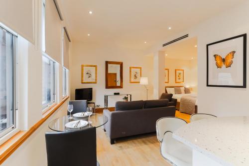 a living room with a couch and a table at Monument by Excel Apartments in London