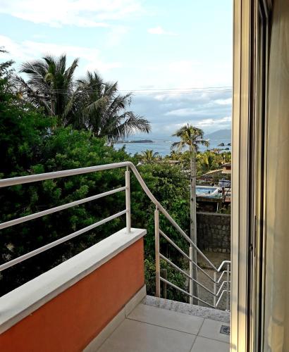 a balcony with a view of the ocean at Suítes Cambucá in Ilhabela