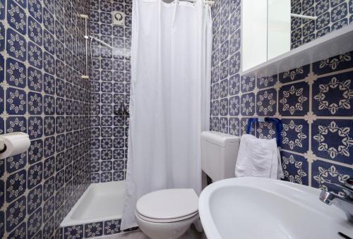 a bathroom with a toilet and a sink and a shower at Apartments Marija & Lino in Lopar