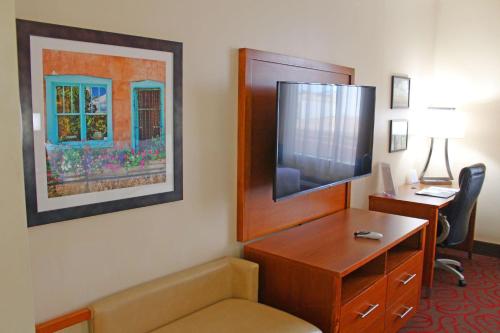 a hotel room with a desk and a tv at Best Western Cannon A.F.B. in Clovis