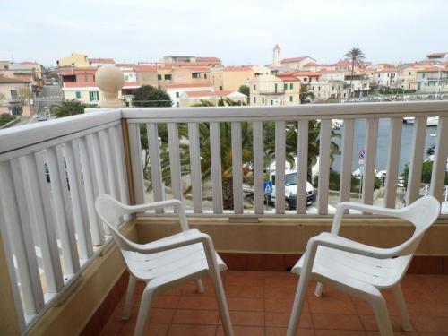 
a row of chairs sitting on top of a balcony at Lina Hotel in Stintino
