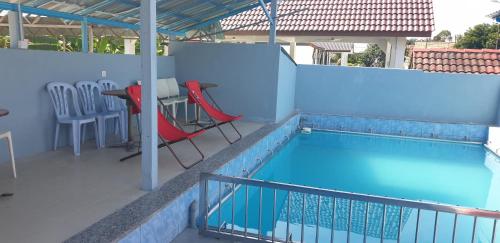 a balcony with a table and chairs next to a swimming pool at MRI Residence - Homestay in Sg Buloh with Swimming Pool - No Pork&Alcohol Allowed in Bandar Puncak Alam