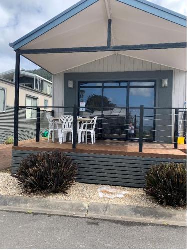 a patio with a table and chairs on a house at Beach Cabin Apollo Bay in Apollo Bay