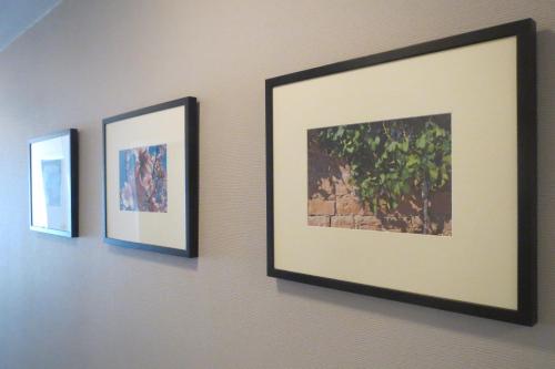 three pictures are hanging on a wall at Lindner's Hotel in Bellheim