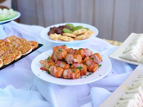 a table topped with plates of food and snacks at CHAU KHUONG HOTEL in Long Xuyên