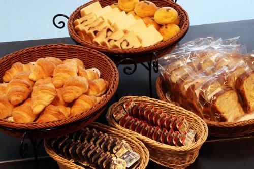 a group of baskets of bread and pastries on a table at JR Inn Sapporo in Sapporo